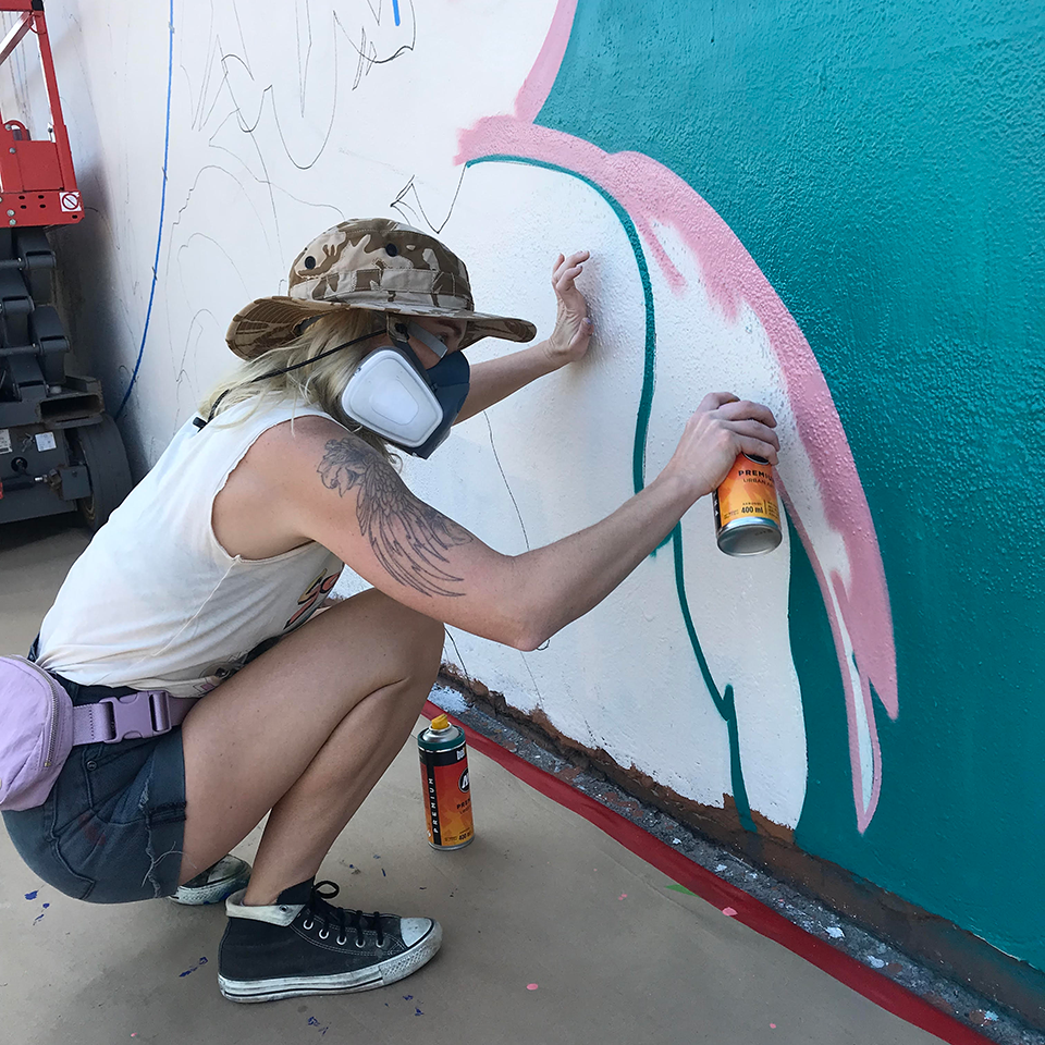 Flox spraypainting a mural 